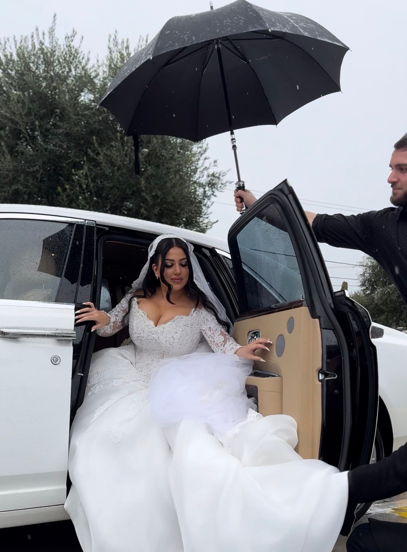 Rolls-Royce, a wedding arrival under the chauffeur's umbrella